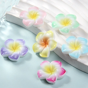Macro shot of 6 gradient resin frangipani flower accessories for DIY hair clips