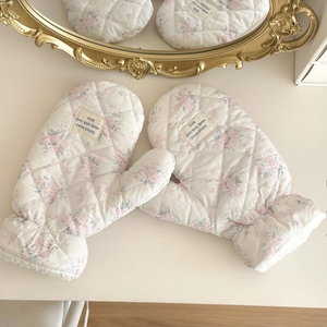 Detail of floral quilted gloves showing the plush lining and fabled brand label