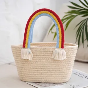 Detail of hand-woven beige tote bag featuring vibrant rainbow handles and tassel accents