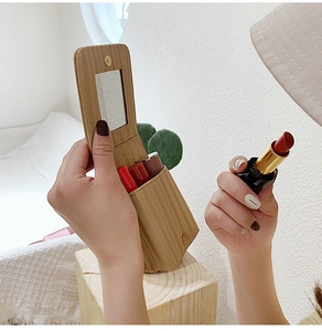 Detailed view of khaki striped leather lipstick case with built-in mirror and magnetic closure