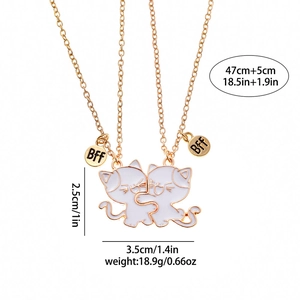 Detail of gold BFF cat pendant necklace with white enamel and size measurements