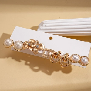 Elegant 10-piece gold floral hair clip set with faux pearls on a premium white card