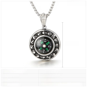 Macro detail of punk style skull compass pendant in cast stainless steel with link chain