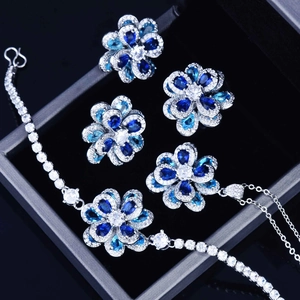 Detailed view of silver camellia flower jewelry set with blue and white zircon stones