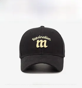 Front view of black cotton baseball cap with yellow fascination embroidery on white background