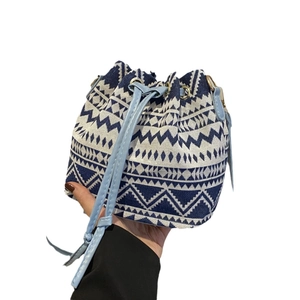 Retro ethnic geometric pattern bucket bag with light blue drawstrings and shoulder strap