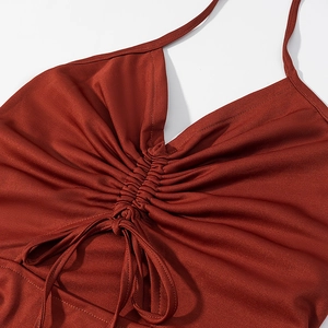 Close-up of rust red ribbed knit halter top with drawstring shirring and tie-up bow detail
