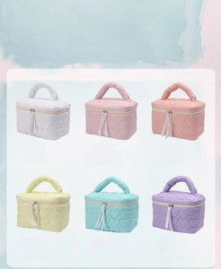 Quilted heart pattern makeup bags in six pastel colors with ribbon zipper pull detail