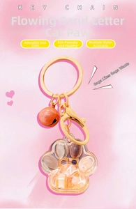 Detail of cat paw quicksand keychain with liquid glitter and golden bell accessory