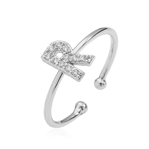 Detailed close-up of a silver open ring featuring a sparkling letter R with clear gems