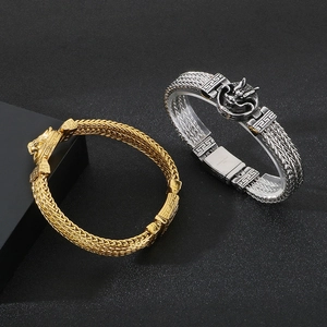Detail of vintage punk dragon head bracelets in gold and silver stainless steel