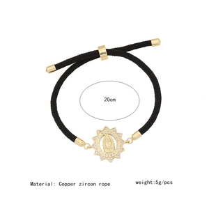 Detail of adjustable black woven bracelet with copper micro-set Virgin Mary charm