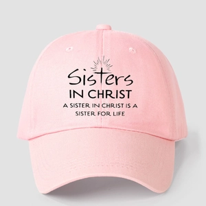Pink cotton baseball cap featuring Sisters in Christ print and cross graphic design