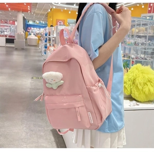 Pink minimalist school backpack with floral charm and drawstring side pockets for girls