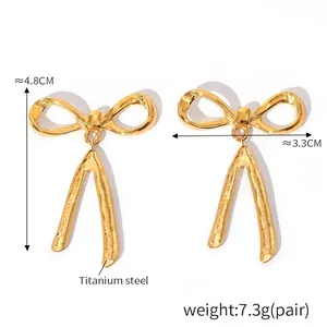 Detailed macro view showing dimensions of 18K gold plated bow ribbon tassel earrings