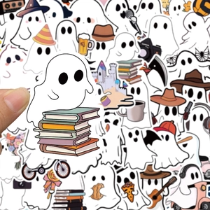Close-up of a cute cartoon ghost sticker on books with hand for size reference