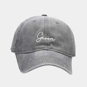 Detail of washed grey cotton baseball cap with white Groom embroidery and fine stitching