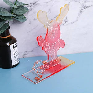 Detailed view of a Christmas reindeer resin figurine with gold foil base on marble desk