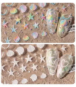 Macro detail of 5D embossed sea shell and starfish nail stickers with pearl necklace design