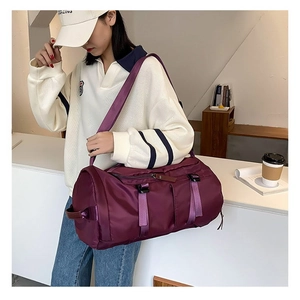 Detail view of purple nylon travel bag showing waterproof fabric and functional buckles