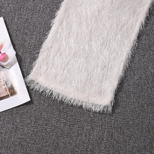 Gros plan sur la texture du tissu en peluche blanc crème pour pantalon de loisirs