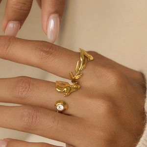 Close-up of 18K gold plated olive leaf ring with a clear zircon stone on model finger