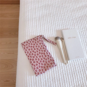 Close-up of a pink butterfly pattern cotton makeup storage bag with a handy wrist strap
