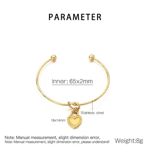 Detailed view of golden stainless steel knotted bangle with heart pendant and dimensions