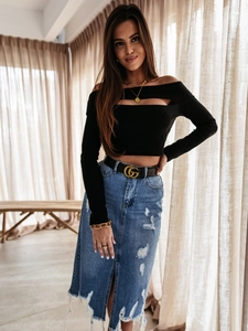 Detail shot of distressed blue denim midi skirt with fringe hem and off-shoulder knit top
