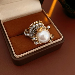 Detail of vintage flower ring with white pearls in a premium velvet jewelry box