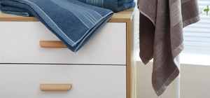 Detailed close-up of blue and gray thick cotton towels showing the soft absorbent texture