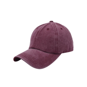 Detail of vintage washed wine red baseball cap with retro cotton texture and curved brim