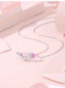 Macro shot of 925 sterling silver necklace with pink heart gem and star pendant