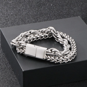 Detail of double-layer stainless steel Cuban chain bracelet with textured metal links