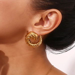 Close-up of 18K gold plated stainless steel twisted hoop earrings on female model