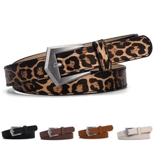 Close-up of leopard print and solid faux leather belts with silver geometric buckles