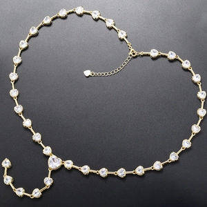 Detailed view of the heart-shaped crystal links on this golden jewelry set necklace