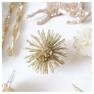 Detailed view of champagne gold glitter reindeer and star ornaments for Christmas tree decoration