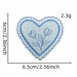 Detail view of blue heart embroidered patch with precise fabric texture and size dimensions