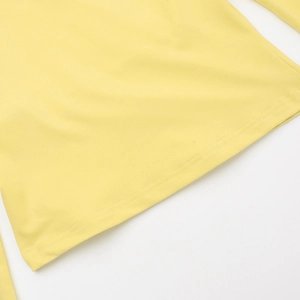 Close-up of the professional hem stitching on a yellow square neck casual outfit