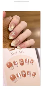 Detail of nude pink cat eye press-on nails with white French tips and 3D bow accents