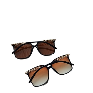 Fashion oversized square sunglasses with black frame and golden chain detail for women