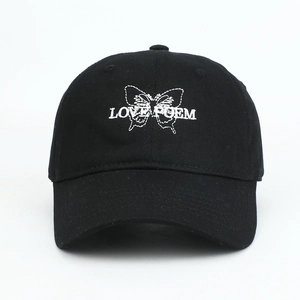Detailed macro view of white butterfly embroidery on front of black baseball cap