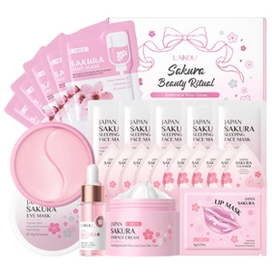 Detailed set of pink cherry blossom skincare products including clay masks and serums