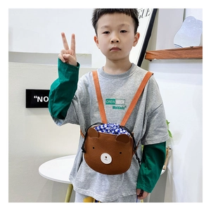Detail of cute brown bear kid crossbody bag with blue plaid drawstring and orange strap