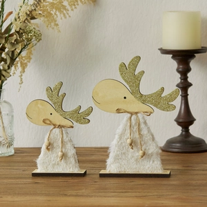 Wooden Christmas reindeer set with white faux fur and gold glitter on table