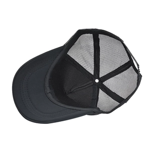 Detail view of black trucker hat showing breathable mesh and inner reinforced sweatband