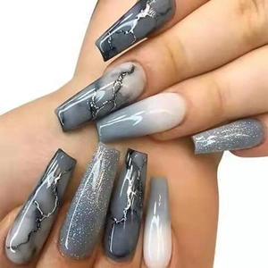Detail of long coffin nails featuring grey marble texture and sparkling glitter accents