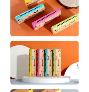 Detail view of colorful 16-hole wooden harmonicas with cute cartoon giraffe patterns