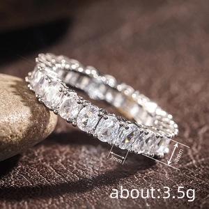 Oval cut eternity wedding band with clear stones on pebbles and brown leather